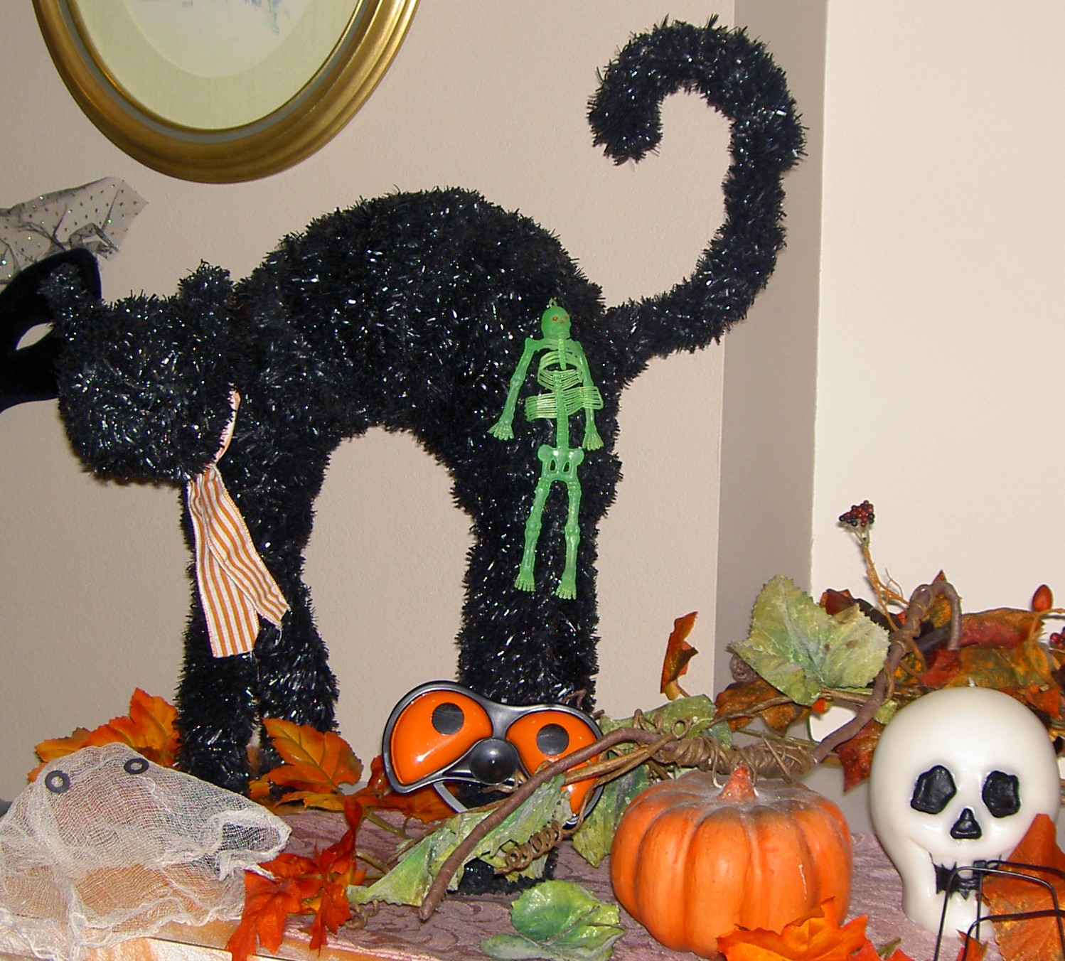 black cat with pumpkin and other fall decor
